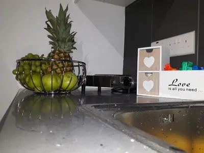 a bowl of fruit on a counter with a pineapple at Takis apartments in Ayia Napa