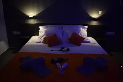 a bedroom with a bed with blue items on it at Takis apartments in Ayia Napa