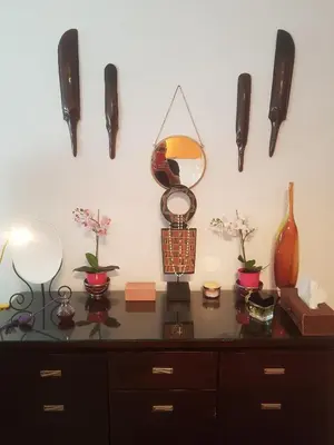 a dresser with a mirror and vases on it at Sylvias art studio apt in Ayia Napa