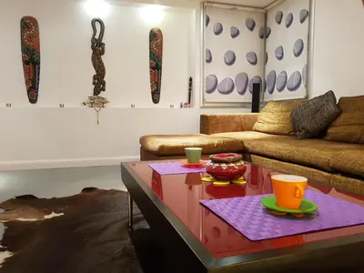 a living room with a couch and a table at Sylvias art studio apt in Ayia Napa
