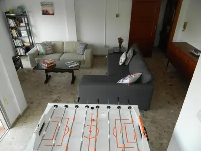 a living room with a couch and a table at Family Nest In The Heart Of Limassol in Limassol