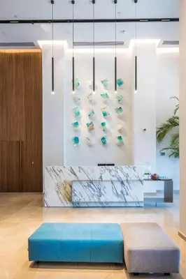 a lobby with a blue bench in front of a wall at Radisson Blu Hotel, Larnaca in Larnaka