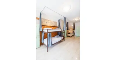 a room with a bed and a mirror at House of Nissus Hostel in Ayia Napa
