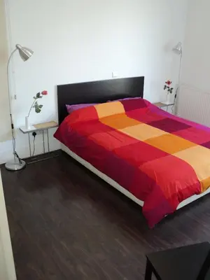 a bedroom with a bed with a colorful blanket at The Kapitani Residence in Nicosia