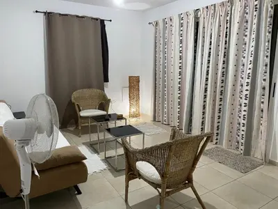 a living room with a couch and chairs at Tranquil Country Condo - Tersefanou in Larnaka