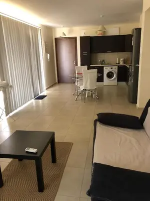 a living room with a couch and a table at Tranquil Country Condo - Tersefanou in Larnaka