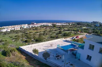 an aerial view of a house and the ocean at Aetopetra Villa in Protaras