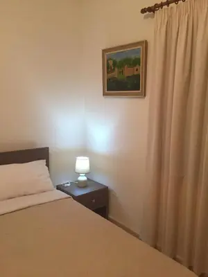 a bedroom with a bed and a lamp on a table at Artemis House in Limassol
