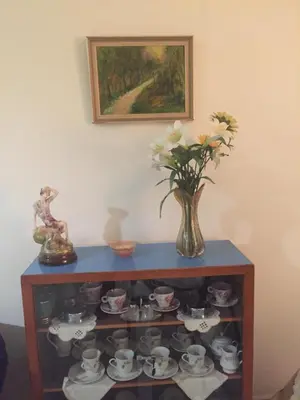 a table with a vase of flowers and tea sets at Artemis House in Limassol