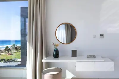 a bathroom with a mirror and a white sink at Beachfront Luxury Villa Glory in Ayia Napa