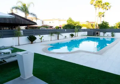 a swimming pool in the middle of a yard at Kypkeys Apartments in Voroklini