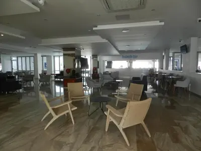 a lobby with chairs and tables in a building at Evabelle Napa Hotel Apartments in Ayia Napa
