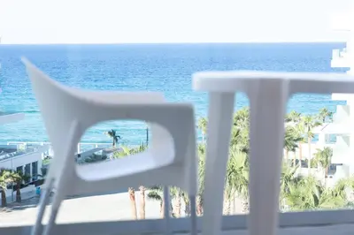a view of the ocean from the balcony of a resort at Vrissaki Hotel Apartments in Protaras