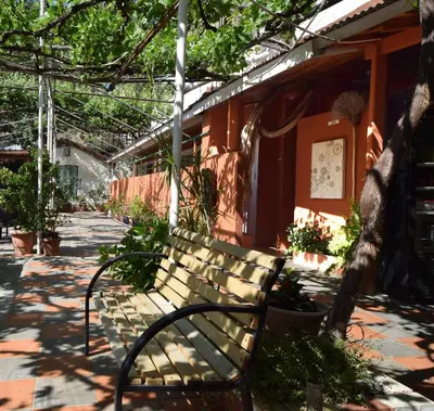 a bench sitting in front of a building at Christys Palace Hotel in Pedoulas