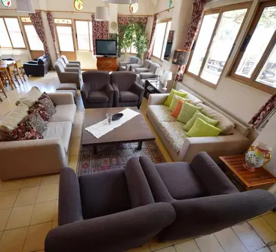 a large living room with couches and tables at Christys Palace Hotel in Pedoulas
