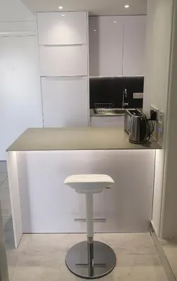 a counter with a stool in a kitchen at Lykavitos Apartments in Nicosia