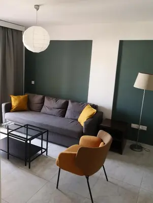 a living room with a couch and a chair at Lykavitos Apartments in Nicosia