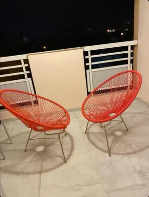 two red chairs sitting on top of a balcony at Lykavitos Apartments in Nicosia