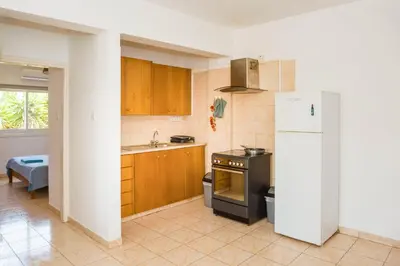 a kitchen with a refrigerator and a sink at MyNapa Apartments in Ayia Napa