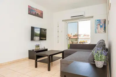a living room with a couch and a table at MyNapa Apartments in Ayia Napa