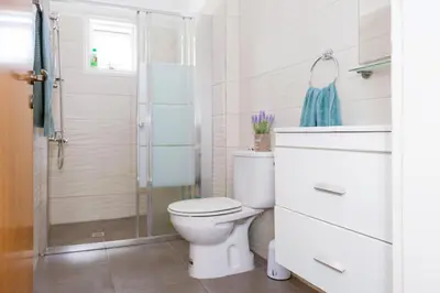 a bathroom with a toilet and a shower at MyNapa Apartments in Ayia Napa