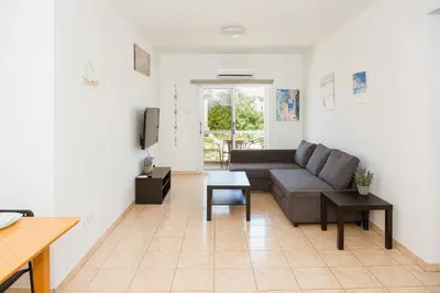 a living room with a couch and a table at MyNapa Apartments in Ayia Napa