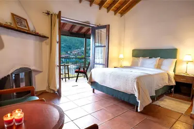 a bedroom with a large bed and a fireplace at Ambelikos Traditional Agrohotel in Potamitissa