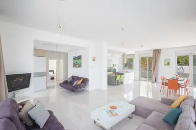 a living room with a couch and a table at Villa Gardenia in Protaras