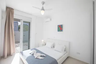 a bedroom with a bed with a stuffed animal on it at Villa Gardenia in Protaras