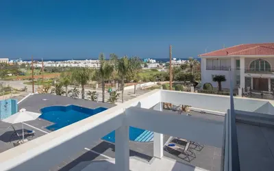 a view of the pool from the balcony of a apartment at Villa Gardenia in Protaras
