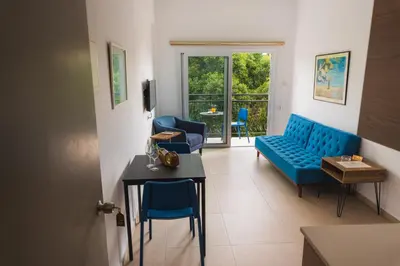 a living room with a blue couch and a table at Chrielka Hotel in Limassol