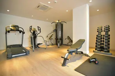 a gym with several exercise equipment in a room at Sunrise Gardens Aparthotel in Protaras