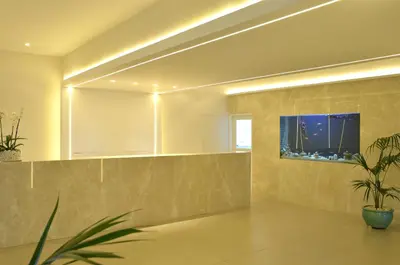 a lobby with a mirror and a potted plant at Sunrise Gardens Aparthotel in Protaras