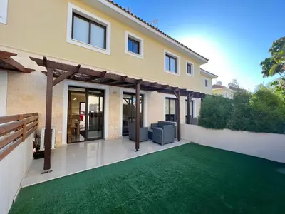 a house with a green lawn in front of it at Kapparis town house in Paralimni