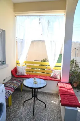 a room with a bench and a table and a window at Lucky 4 in Paralimni