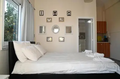 a large bed in a room with a large window at Lucky 4 in Paralimni