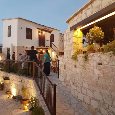 a group of people standing on a balcony of a building at Olympia Traditional Houses in Lymbia