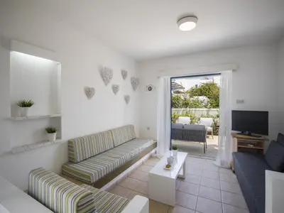 a living room with a couch and a tv at Protaras Villa Stef in Protaras