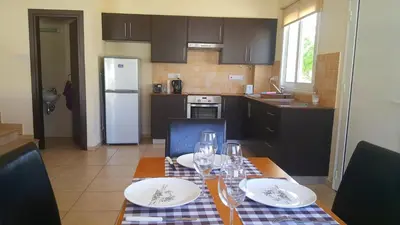 a kitchen with a table with wine glasses on it at BG06 Mythical Sands in Paralimni