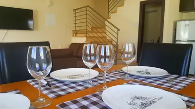 a table with wine glasses and plates on it at BG06 Mythical Sands in Paralimni