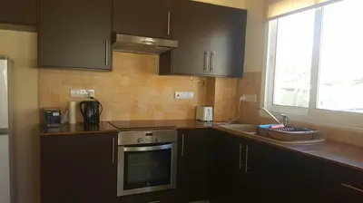 a kitchen with a sink and a stove top oven at BG06 Mythical Sands in Paralimni
