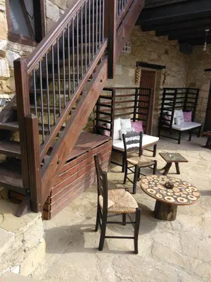 a patio with chairs and tables and a staircase at Teacher's House in Maroni
