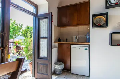 a kitchen with a white refrigerator and a window at Kalavasos View Traditional Apartments in Kalavasos