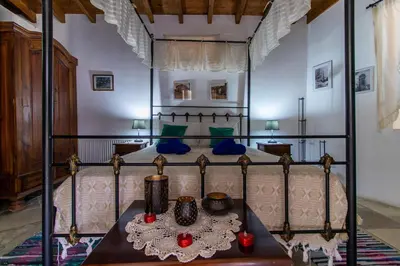 a bedroom with a canopy bed with blue pillows at Kalavasos View Traditional Apartments in Kalavasos