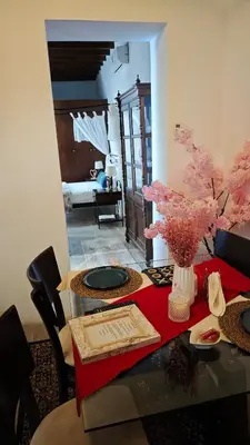 a dining room with a table with a red table cloth at Kozakos Luxury House in Pano Lefkara