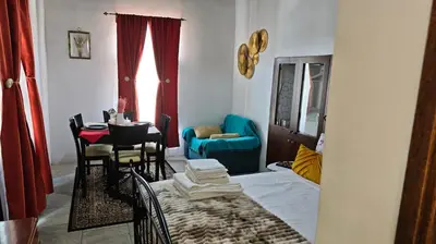 a room with a table and chairs and a room with a bed at Kozakos Luxury House in Pano Lefkara