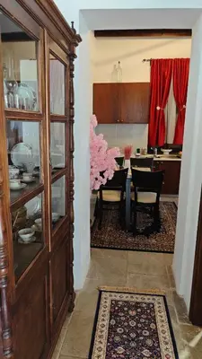 a dining room and kitchen with a large wooden cabinet at Kozakos Luxury House in Pano Lefkara