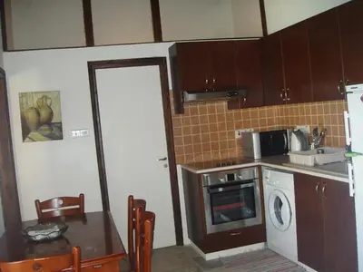 a small kitchen with a sink and a microwave at Vrakas House in Tochni