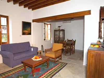 a living room with a couch and a table at Porfyrios Country House in Chirokitia