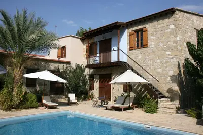 a villa with a swimming pool and a house at Porfyrios Country House in Chirokitia